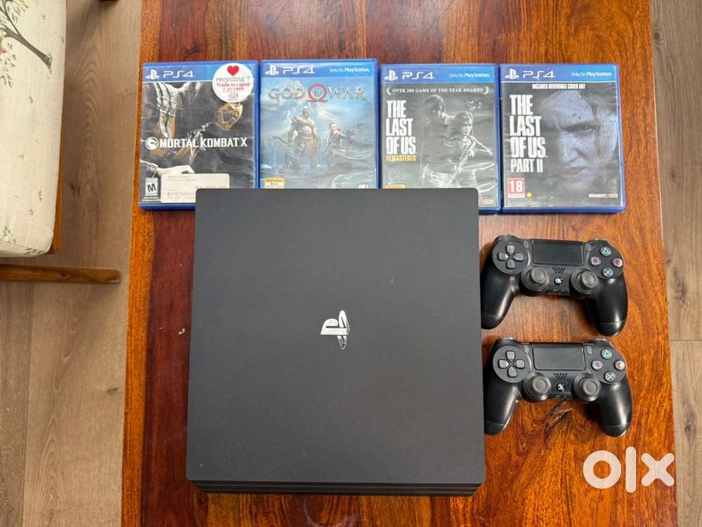 PlayStation 4 Pro (1 tb) console with 2 controllers and 4 games.