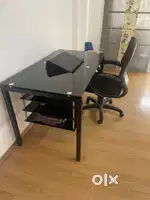 Home center large study table with revolving chair. In good condition