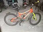 A Orange colour bicycle with some neon colour