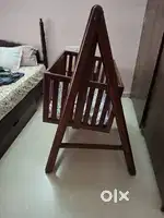 Wooden baby cradle on stand
