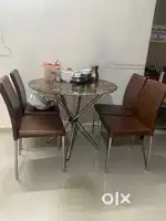 Dining table with tampard glass top