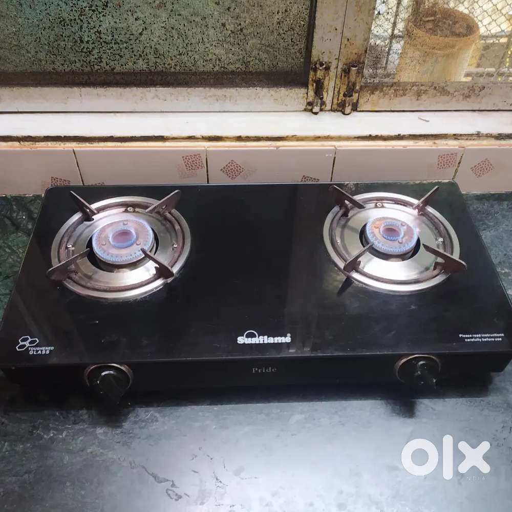 Sunflame branded 2 burner gas stove with PNG fitted. Black glass top.