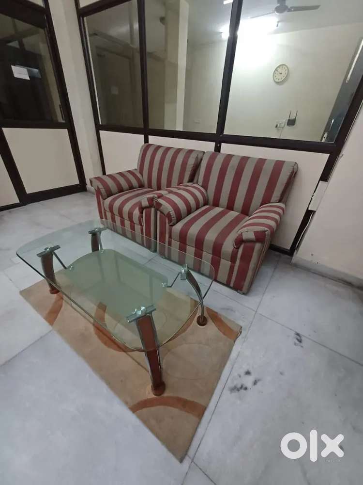 Fully upholstered sofa set with glass center table