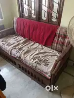 Wooden sofa cum bed with cushions