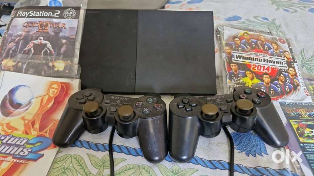 SONY PS2 with 2 Controllers & games CD's