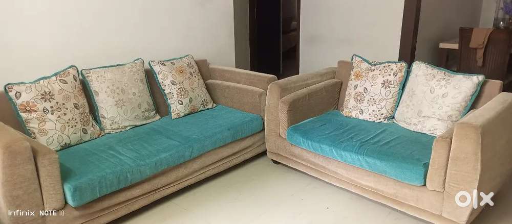 Sofa in L Shaped with pillows.
