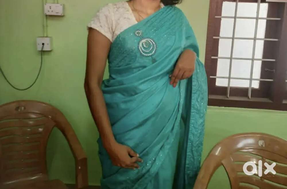 Elegant Turquoise Blue Saree with White Lace Blouse .