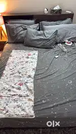 Cot and bed with two pillows