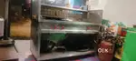 Fast food container.d fridge . Chair tables cash counter