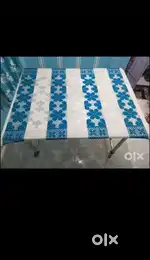 A glass dining table with thickest glass and full free wheels
