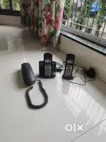 Two Cordless telephone intruments and one wall hanging  instruments
