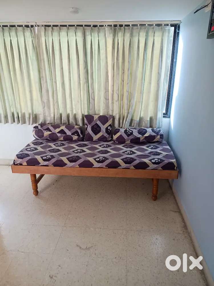 2 wooden beds with mattresses