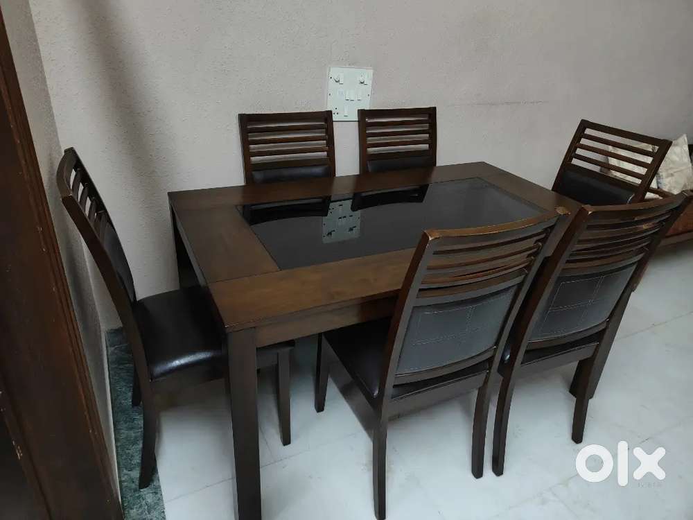 Six seater imported dinning table with designer glass top in between