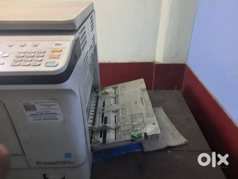 The product in the image is the Toshiba e-STUDIO 2303A multifunction