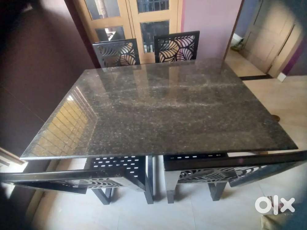 Granite dining table with iron chairs