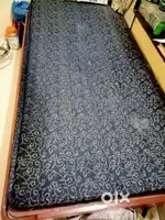 Wooden single bed with mattress
