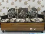 Wooden Sofa set for sell with a wooden table.