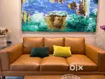 Tan color three seater sofa