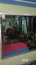 Gym equipments,gym mat,music system,looking glass ( included)used