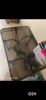 Glass table with steel bottom wheels