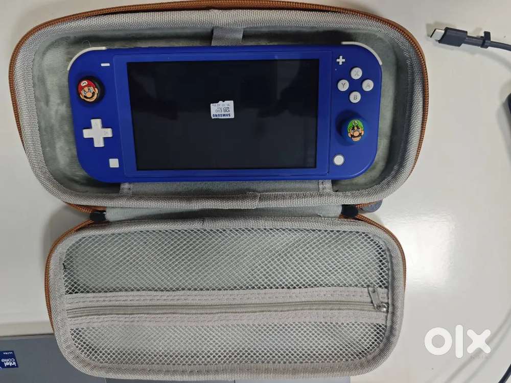 Nintendo switch lite with sd card and finger grip