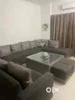 Sofa along with a table and two sethi