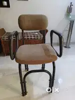 Bottom and Back cushioned metallic chair with arm support