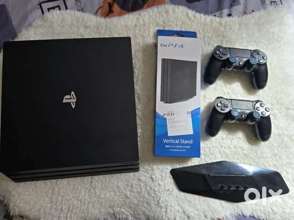 PS4 PRO 1TB 4k model with 2 original controllers , vertical stand .
