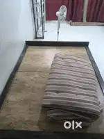 Double bed with mattress in the photo