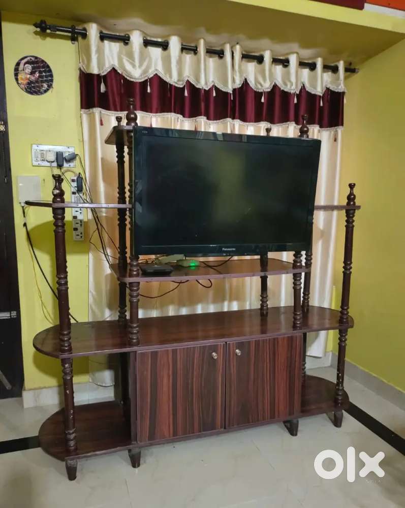 Tv stand having large open and closed cupboards