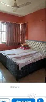 King size bed and wooden dining table with 4 chairs