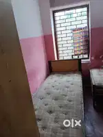 Single wooden bed and cupboard