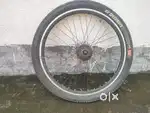 This is a rear alloy rim with a tyre and tube and a 7 speed freewheel